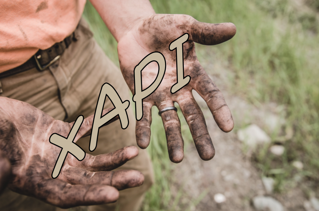 Muddy hands holding xAPI